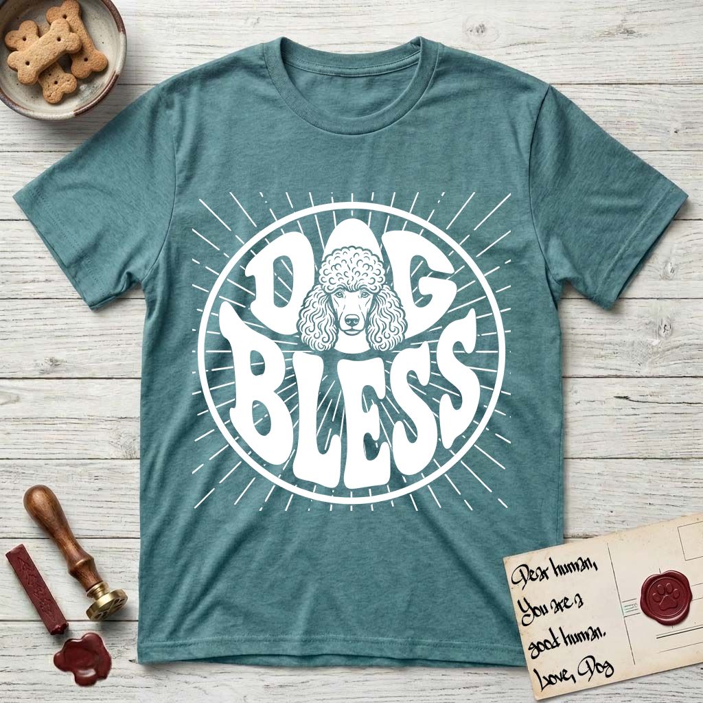 Dog Bless Poodle T-Shirt flat lay in Heather Galapagos Blue, featuring Retro bubble-letter badge reading DOG BLESS with a Poodle face with curly topknot and long curled ears framed in the letter O, hand-drawn sunburst rays radiating outward.