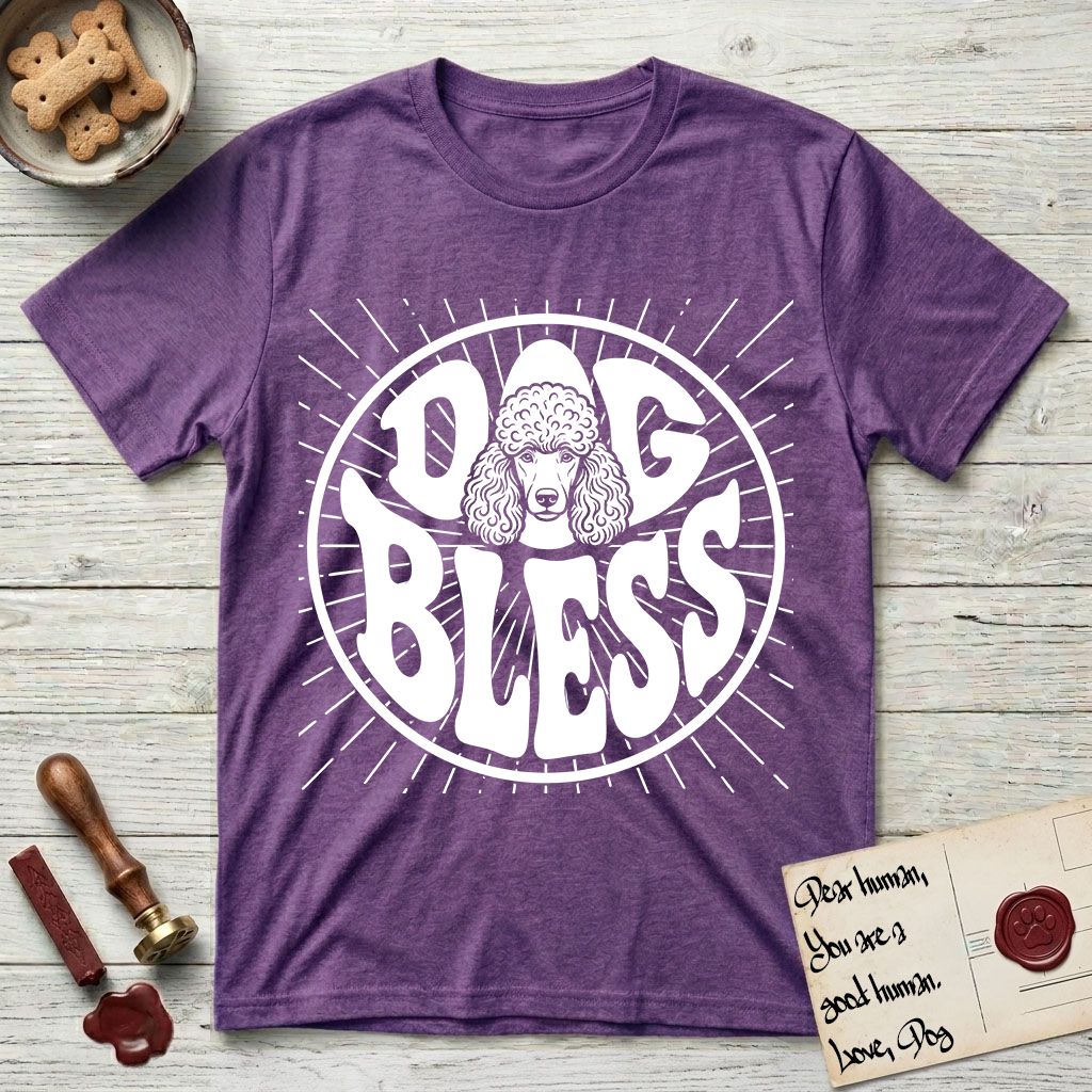 Dog Bless Poodle T-Shirt flat lay in Heather Purple, featuring Retro bubble-letter badge reading DOG BLESS with a Poodle face with curly topknot and long curled ears framed in the letter O, hand-drawn sunburst rays radiating outward.