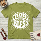 Dog Bless Pug T-Shirt flat lay in Kiwi, featuring Retro bubble-letter badge reading DOG BLESS with a wrinkled Pug face with large round eyes framed in the letter O, hand-drawn sunburst rays radiating outward.