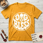 Dog Bless Schnauzer T-Shirt flat lay in Gold, featuring Retro bubble-letter badge reading DOG BLESS with a bearded Schnauzer face with bushy eyebrows framed in the letter O, hand-drawn sunburst rays radiating outward.