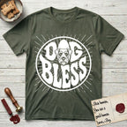 Dog Bless Schnauzer T-Shirt flat lay in Heather Military Green, featuring Retro bubble-letter badge reading DOG BLESS with a bearded Schnauzer face with bushy eyebrows framed in the letter O, hand-drawn sunburst rays radiating outward.