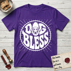 Dog Bless Weimaraner T-Shirt flat lay in Purple, featuring Retro bubble-letter badge reading DOG BLESS with a sleek Weimaraner face with long velvet ears framed in the letter O, hand-drawn sunburst rays radiating outward.