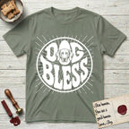 Dog Bless Weimaraner T-Shirt flat lay in Sage, featuring Retro bubble-letter badge reading DOG BLESS with a sleek Weimaraner face with long velvet ears framed in the letter O, hand-drawn sunburst rays radiating outward.