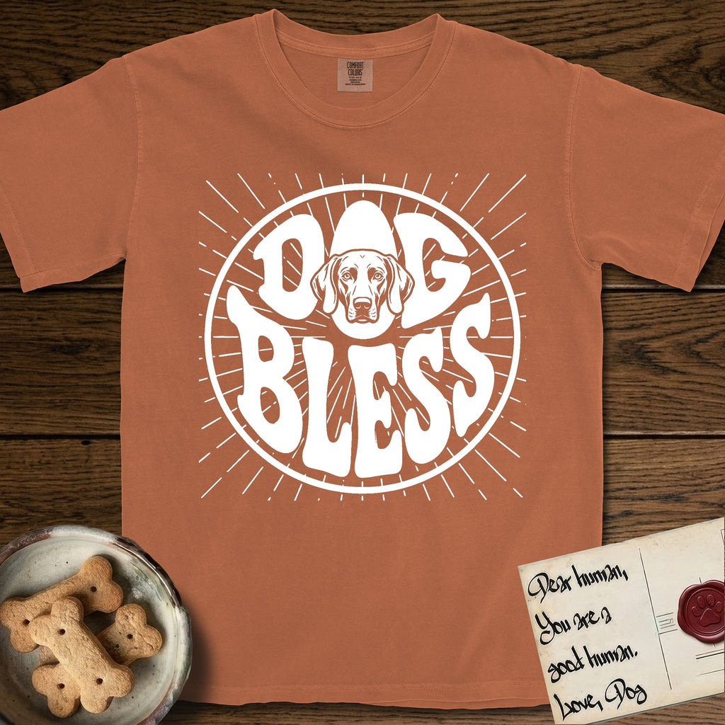 Dog Bless Weimaraner T-Shirt flat lay in Yam, featuring Retro bubble-letter badge reading DOG BLESS with a sleek Weimaraner face with long velvet ears framed in the letter O, hand-drawn sunburst rays radiating outward.