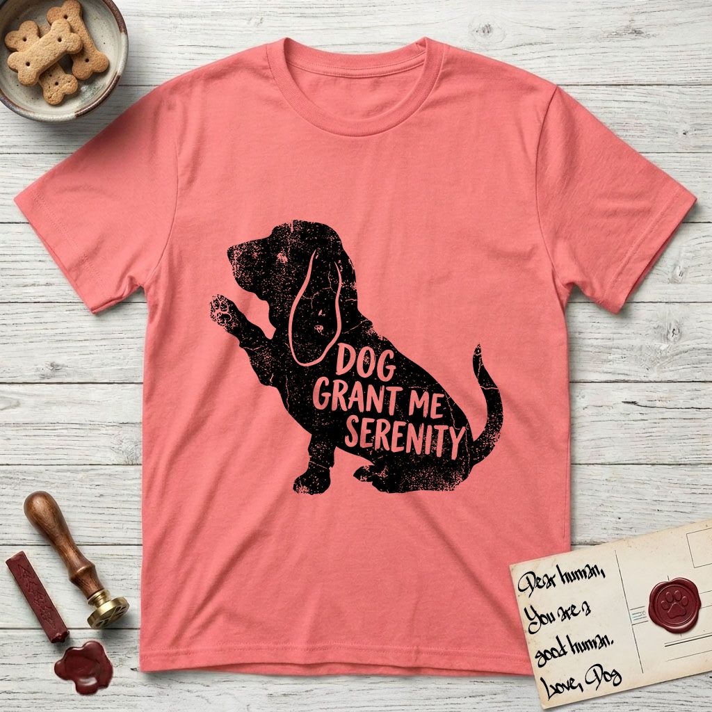 Serenity Basset Hound T-Shirt flat lay in Coral Silk, featuring Distressed black screen print silhouette of a Basset Hound sitting in profile with one paw raised and long ears hanging, the words DOG GRANT ME SERENITY showing through his body in the shirt color.