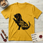 Serenity Basset Hound T-Shirt flat lay in Daisy, featuring Distressed black screen print silhouette of a Basset Hound sitting in profile with one paw raised and long ears hanging, the words DOG GRANT ME SERENITY showing through his body in the shirt color.