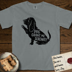 Serenity Basset Hound T-Shirt flat lay in Granite, featuring Distressed black screen print silhouette of a Basset Hound sitting in profile with one paw raised and long ears hanging, the words DOG GRANT ME SERENITY showing through his body in the shirt color.