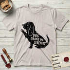 Serenity Basset Hound T-Shirt flat lay in Ice Grey, featuring Distressed black screen print silhouette of a Basset Hound sitting in profile with one paw raised and long ears hanging, the words DOG GRANT ME SERENITY showing through his body in the shirt color.