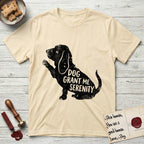 Serenity Basset Hound T-Shirt flat lay in Natural, featuring Distressed black screen print silhouette of a Basset Hound sitting in profile with one paw raised and long ears hanging, the words DOG GRANT ME SERENITY showing through his body in the shirt color.