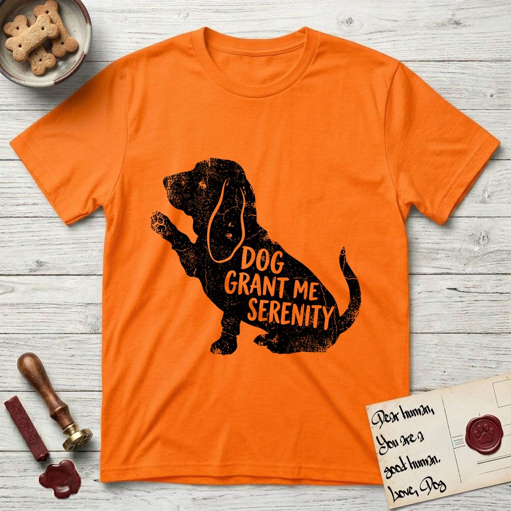 Serenity Basset Hound T-Shirt flat lay in Orange, featuring Distressed black screen print silhouette of a Basset Hound sitting in profile with one paw raised and long ears hanging, the words DOG GRANT ME SERENITY showing through his body in the shirt color.