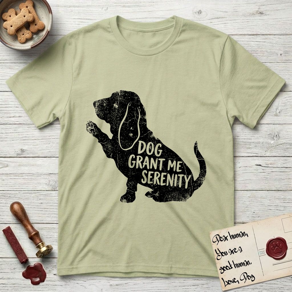Serenity Basset Hound T-Shirt flat lay in Pistachio, featuring Distressed black screen print silhouette of a Basset Hound sitting in profile with one paw raised and long ears hanging, the words DOG GRANT ME SERENITY showing through his body in the shirt color.