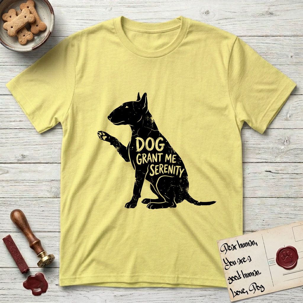Serenity Bull Terrier T-Shirt flat lay in Cornsilk, featuring Distressed black screen print silhouette of a Bull Terrier sitting in profile with one paw raised and an egg-shaped head, the words DOG GRANT ME SERENITY showing through her body in the shirt color.