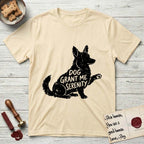 Serenity Corgi T-Shirt flat lay in Natural, featuring Distressed black screen print silhouette of a Corgi sitting in profile with one paw raised, upright ears and a full brush tail, the words DOG GRANT ME SERENITY showing through his body in the shirt color.