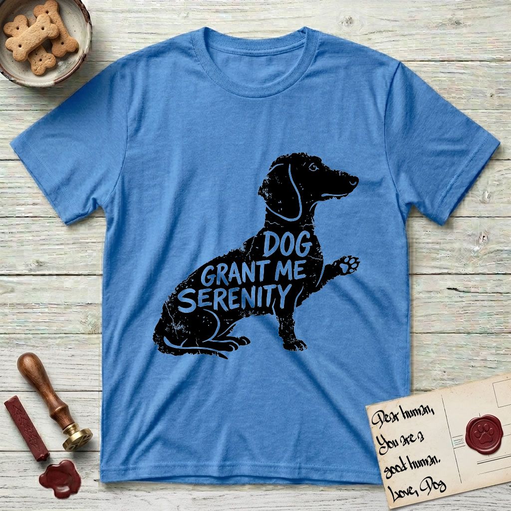 Serenity Dachshund T-Shirt flat lay in Heather Sapphire, featuring Distressed black screen print silhouette of a Dachshund sitting in profile with one paw raised, a long low body and long hanging ears, the words DOG GRANT ME SERENITY showing through her body in the shirt color.