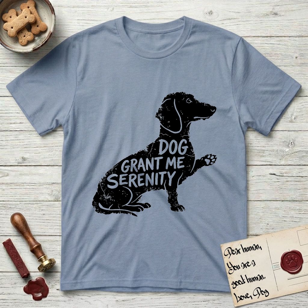 Serenity Dachshund T-Shirt flat lay in Stone Blue, featuring Distressed black screen print silhouette of a Dachshund sitting in profile with one paw raised, a long low body and long hanging ears, the words DOG GRANT ME SERENITY showing through her body in the shirt color.