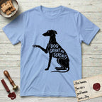 Serenity Greyhound T-Shirt flat lay in Light Blue, featuring Distressed black screen print silhouette of a Greyhound sitting in profile with one paw raised, an arched back and a long whip tail, the words DOG GRANT ME SERENITY showing through her body in the shirt color.