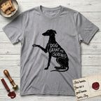 Serenity Greyhound T-Shirt flat lay in Sport Grey, featuring Distressed black screen print silhouette of a Greyhound sitting in profile with one paw raised, an arched back and a long whip tail, the words DOG GRANT ME SERENITY showing through her body in the shirt color.