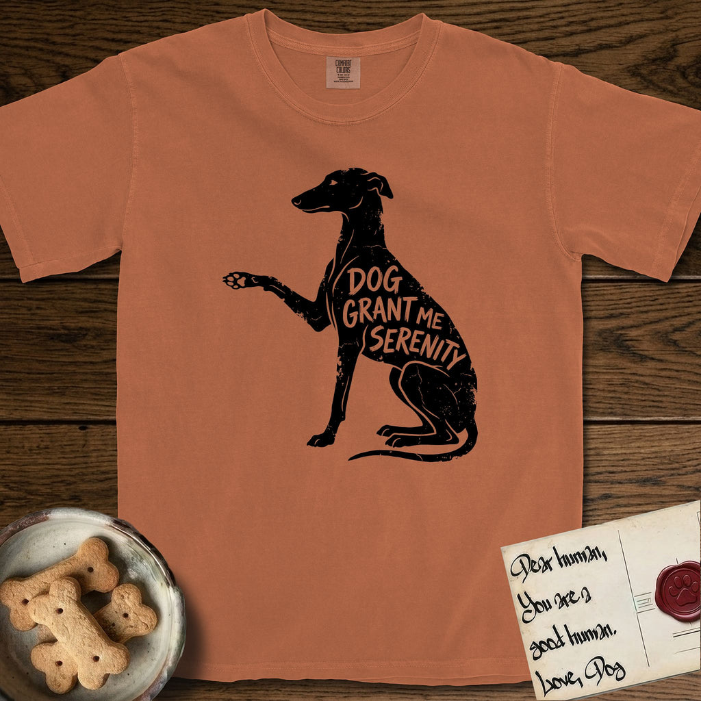 Serenity Greyhound T-Shirt flat lay in Yam, featuring Distressed black screen print silhouette of a Greyhound sitting in profile with one paw raised, an arched back and a long whip tail, the words DOG GRANT ME SERENITY showing through her body in the shirt color.