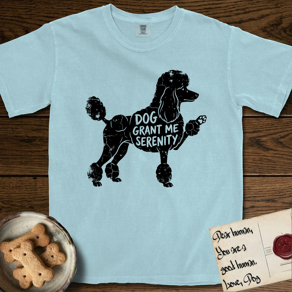 Serenity Poodle T-Shirt flat lay in Chambray, featuring Distressed black screen print silhouette of a Poodle standing in profile with one paw raised, in a continental clip with a topknot and pompons, the words DOG GRANT ME SERENITY showing through her body in the shirt color.