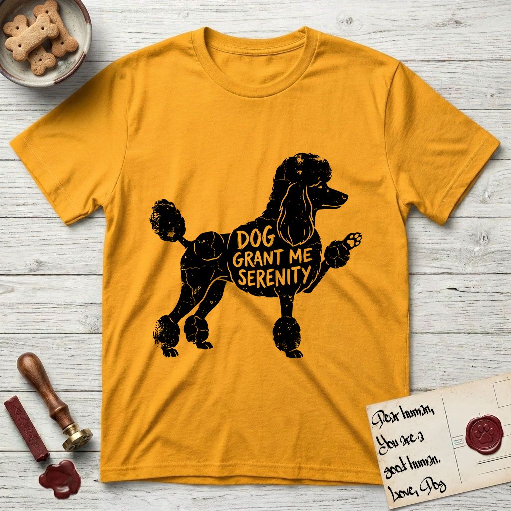 Serenity Poodle T-Shirt flat lay in Gold, featuring Distressed black screen print silhouette of a Poodle standing in profile with one paw raised, in a continental clip with a topknot and pompons, the words DOG GRANT ME SERENITY showing through her body in the shirt color.