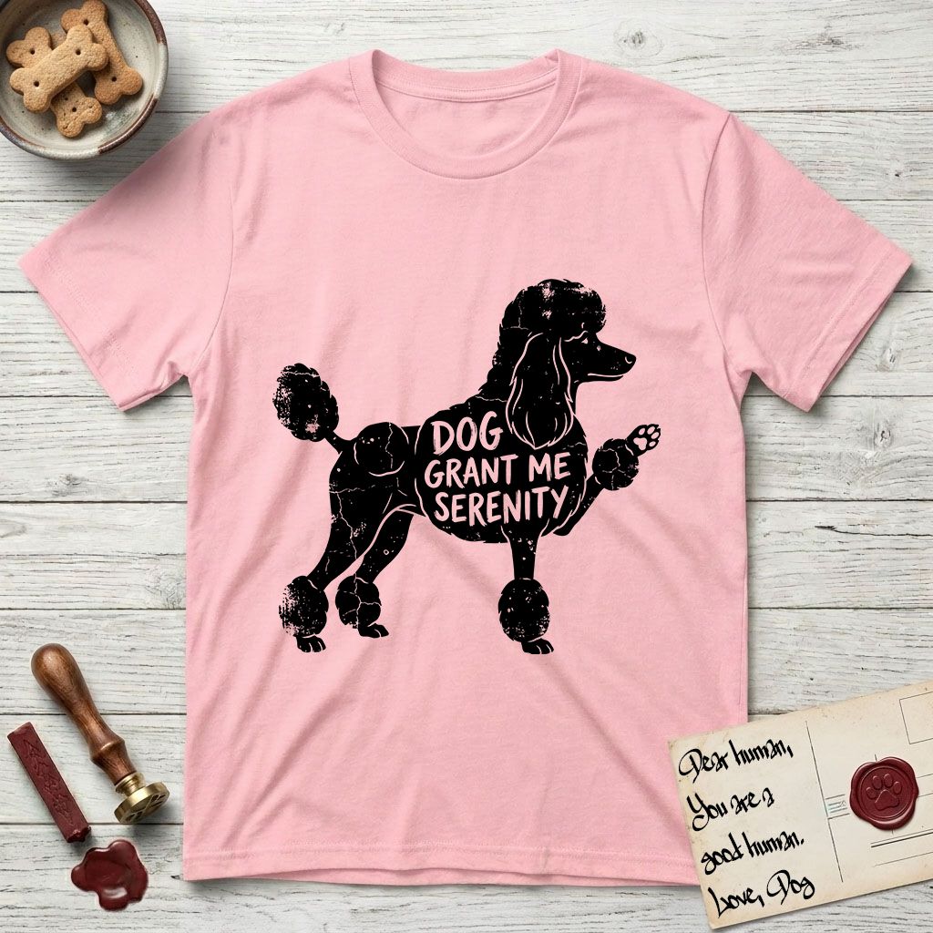 Serenity Poodle T-Shirt flat lay in Light Pink, featuring Distressed black screen print silhouette of a Poodle standing in profile with one paw raised, in a continental clip with a topknot and pompons, the words DOG GRANT ME SERENITY showing through her body in the shirt color.