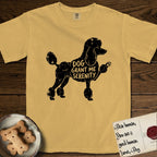 Serenity Poodle T-Shirt flat lay in Mustard, featuring Distressed black screen print silhouette of a Poodle standing in profile with one paw raised, in a continental clip with a topknot and pompons, the words DOG GRANT ME SERENITY showing through her body in the shirt color.