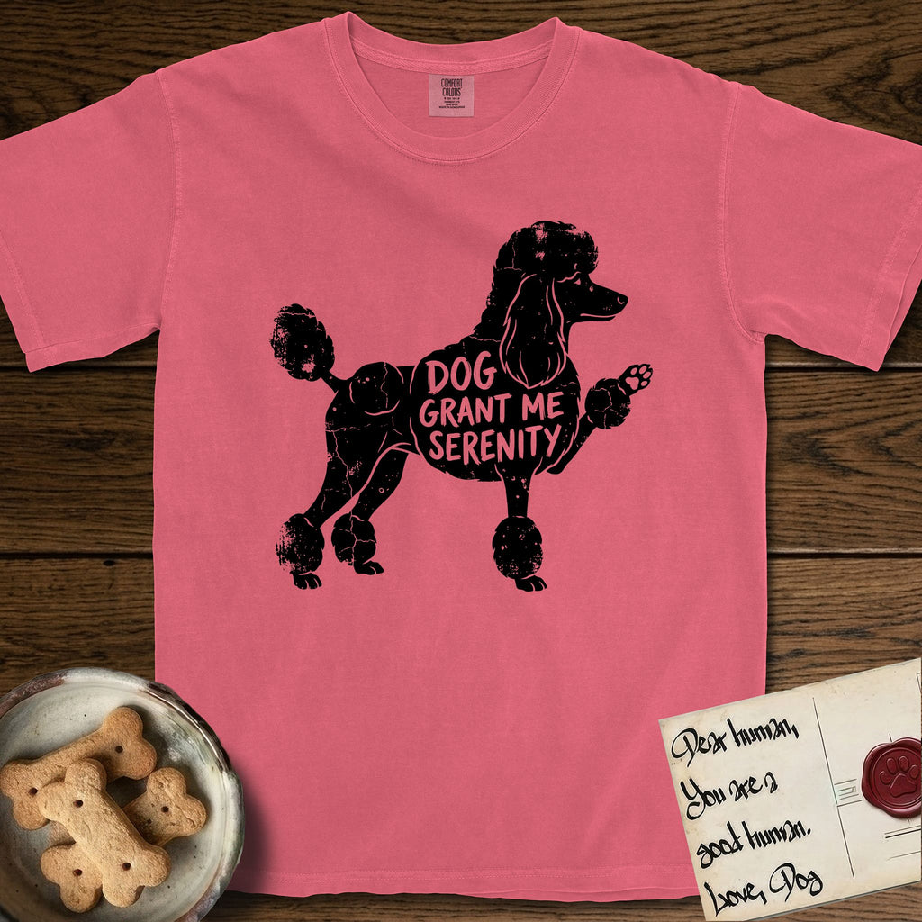 Serenity Poodle T-Shirt flat lay in Watermelon, featuring Distressed black screen print silhouette of a Poodle standing in profile with one paw raised, in a continental clip with a topknot and pompons, the words DOG GRANT ME SERENITY showing through her body in the shirt color.