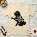 Serenity Pug T-Shirt flat lay in Natural, featuring Distressed black screen print silhouette of a Pug sitting in profile with one paw raised, a wrinkled face and a tightly curled tail, the words DOG GRANT ME SERENITY showing through his body in the shirt color.