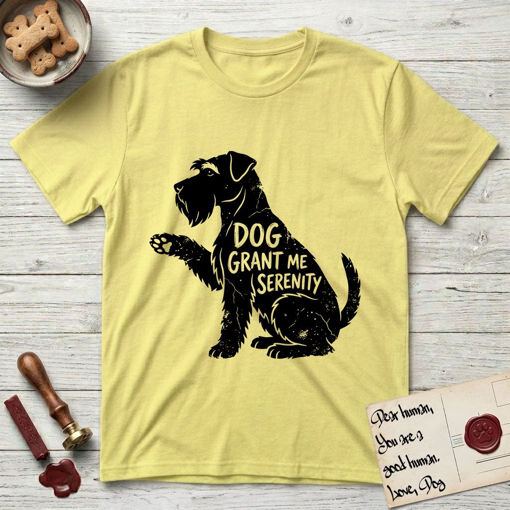 Serenity Schnauzer T-Shirt flat lay in Cornsilk, featuring Distressed black screen print silhouette of a Schnauzer sitting in profile with one paw raised, a long beard and bushy eyebrows, the words DOG GRANT ME SERENITY showing through her body in the shirt color.