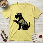 Serenity Schnauzer T-Shirt flat lay in Cornsilk, featuring Distressed black screen print silhouette of a Schnauzer sitting in profile with one paw raised, a long beard and bushy eyebrows, the words DOG GRANT ME SERENITY showing through her body in the shirt color.