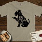 Serenity Schnauzer T-Shirt flat lay in Khaki, featuring Distressed black screen print silhouette of a Schnauzer sitting in profile with one paw raised, a long beard and bushy eyebrows, the words DOG GRANT ME SERENITY showing through her body in the shirt color.