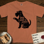 Serenity Schnauzer T-Shirt flat lay in Yam, featuring Distressed black screen print silhouette of a Schnauzer sitting in profile with one paw raised, a long beard and bushy eyebrows, the words DOG GRANT ME SERENITY showing through her body in the shirt color.