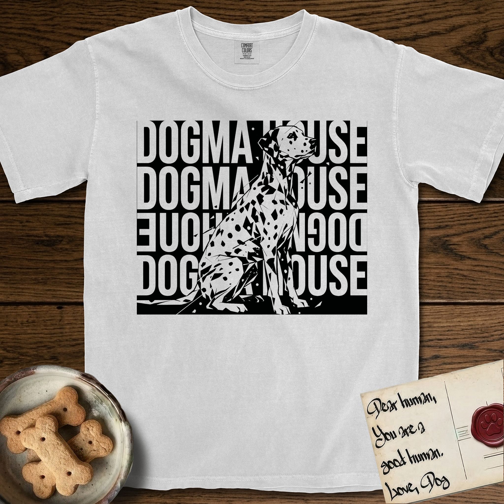Dogma House Dalmatian T-Shirt flat lay in White, featuring a bold streetwear design with DOGMA HOUSE stacked four times in block letters and a geometric angular Dalmatian overlaid on the text.