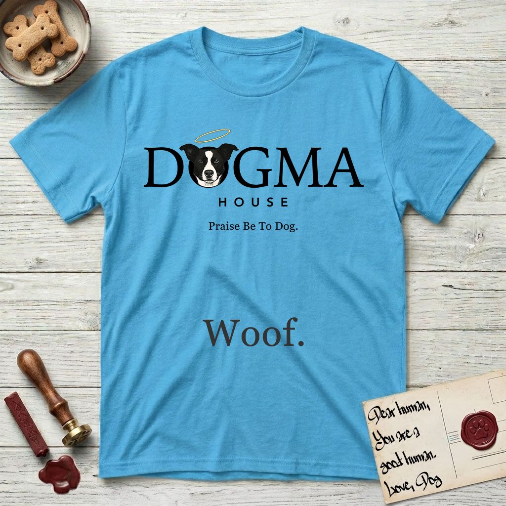 Dogma House Dark Logo T-Shirt flat lay in Sky, featuring the Dogma House wordmark in dark ink with Lobo the mascot forming the O, a halo above him, and HOUSE below.
