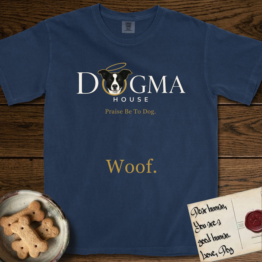 Dogma House Light Logo T-Shirt flat lay in True Navy, featuring the Dogma House wordmark in light ink with Lobo the mascot forming the O, a gold halo above him, and Woof below.