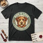 Dog is Love T-Shirt flat lay in Black, featuring a vintage distressed circular badge with a scruffy terrier on a sage-green ground, the words Dog Is Love and Unconditional Forever, and flanking paw prints.