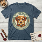 Dog is Love T-Shirt flat lay in Indigo Blue, featuring a vintage distressed circular badge with a scruffy terrier on a sage-green ground, the words Dog Is Love and Unconditional Forever, and flanking paw prints.