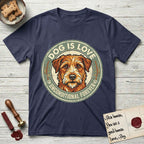 Dog is Love T-Shirt flat lay in Navy, featuring a vintage distressed circular badge with a scruffy terrier on a sage-green ground, the words Dog Is Love and Unconditional Forever, and flanking paw prints.