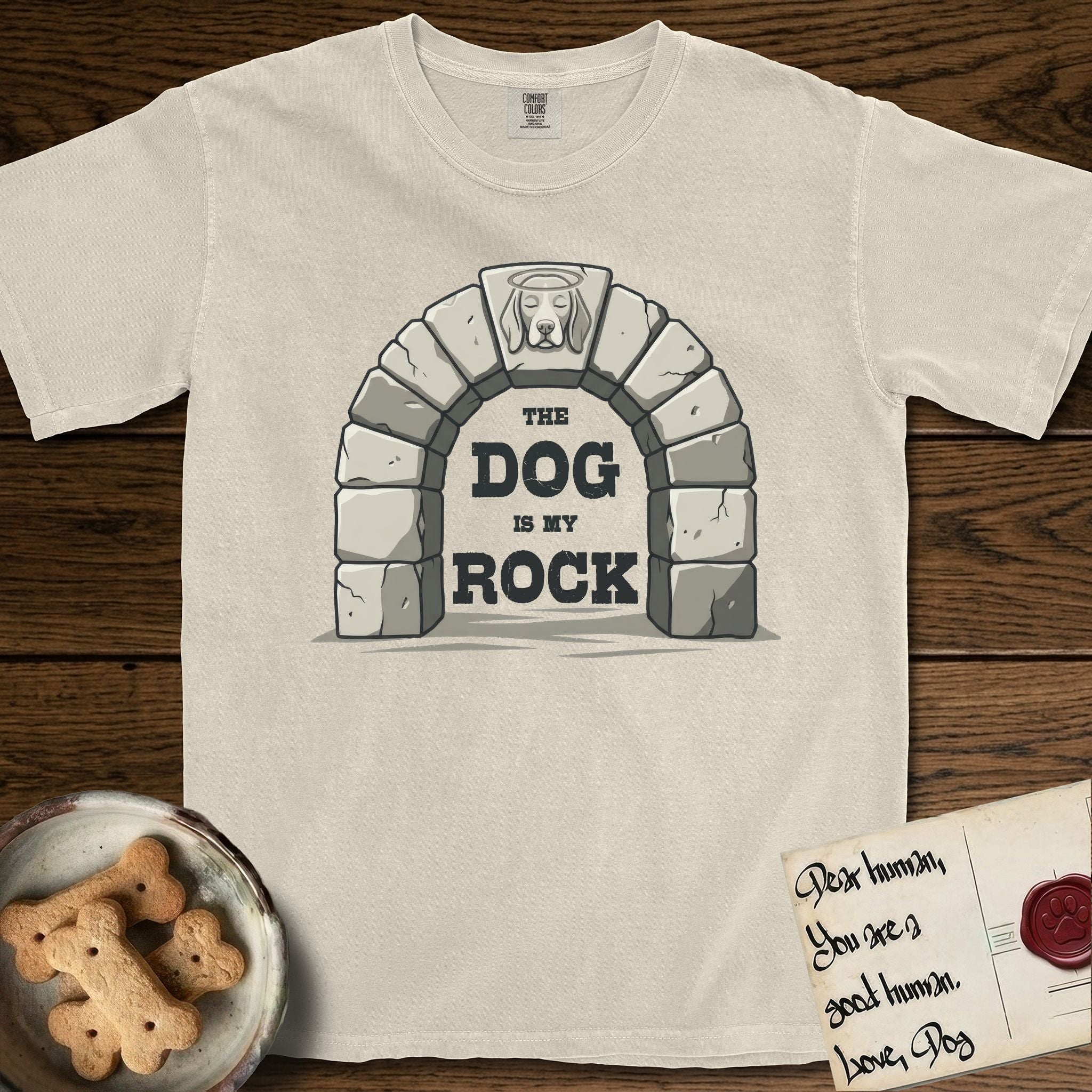 DIMR Beagle T-Shirt flat lay in Ivory, featuring carved gray stone arch with a Beagle's face in shallow relief on the keystone and a halo above, with the words the Dog is my Rock.