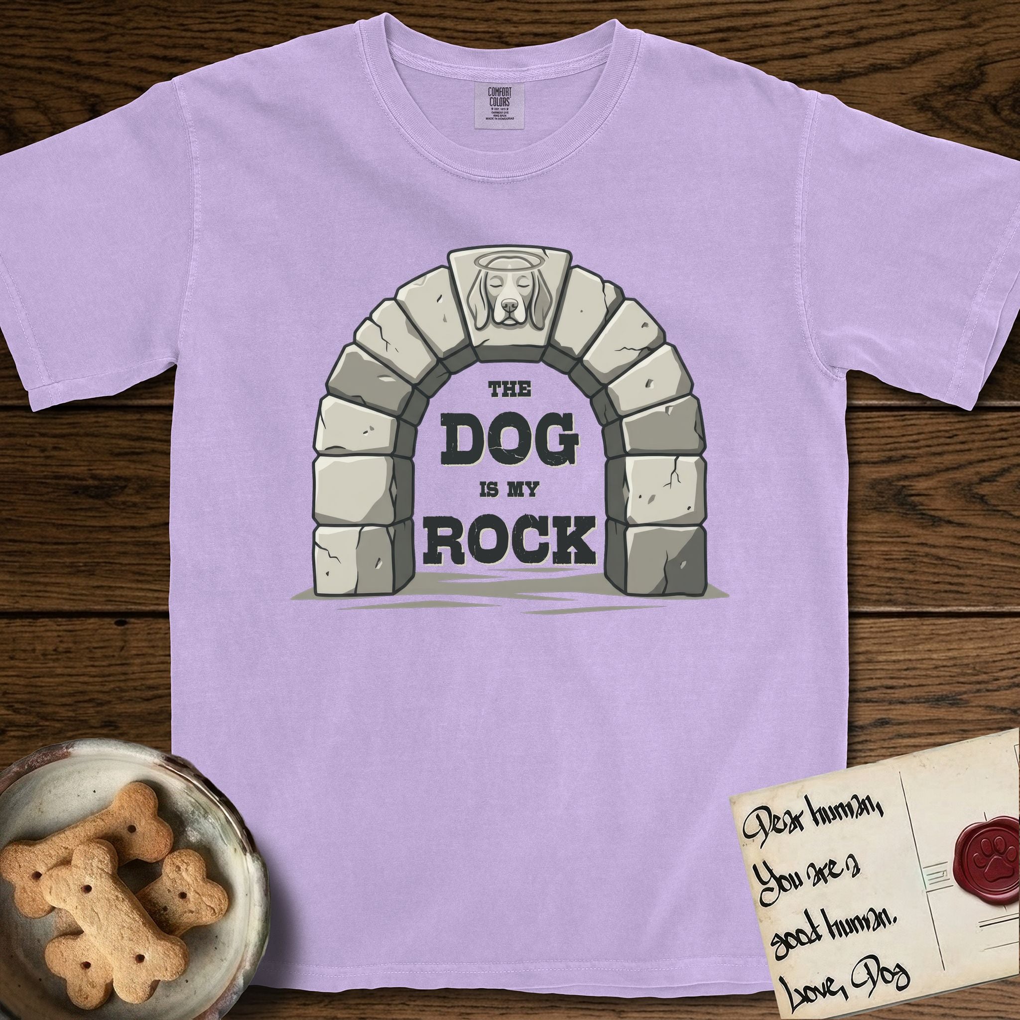 DIMR Beagle T-Shirt flat lay in Orchid, featuring carved gray stone arch with a Beagle's face in shallow relief on the keystone and a halo above, with the words the Dog is my Rock.