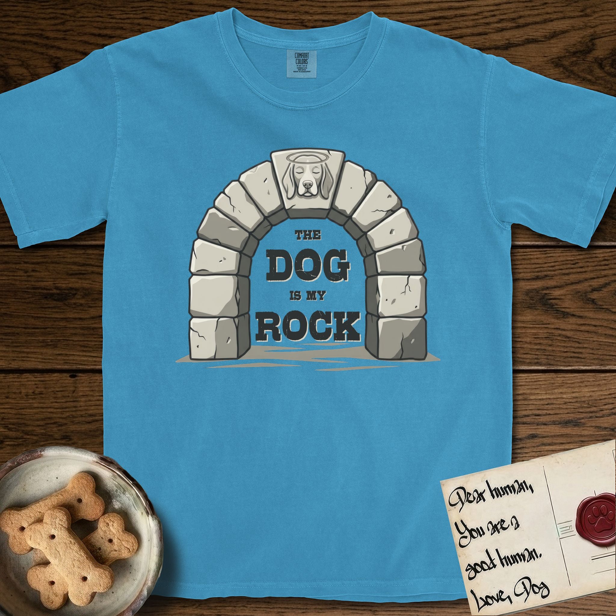 DIMR Beagle T-Shirt flat lay in Royal Caribe, featuring carved gray stone arch with a Beagle's face in shallow relief on the keystone and a halo above, with the words the Dog is my Rock.