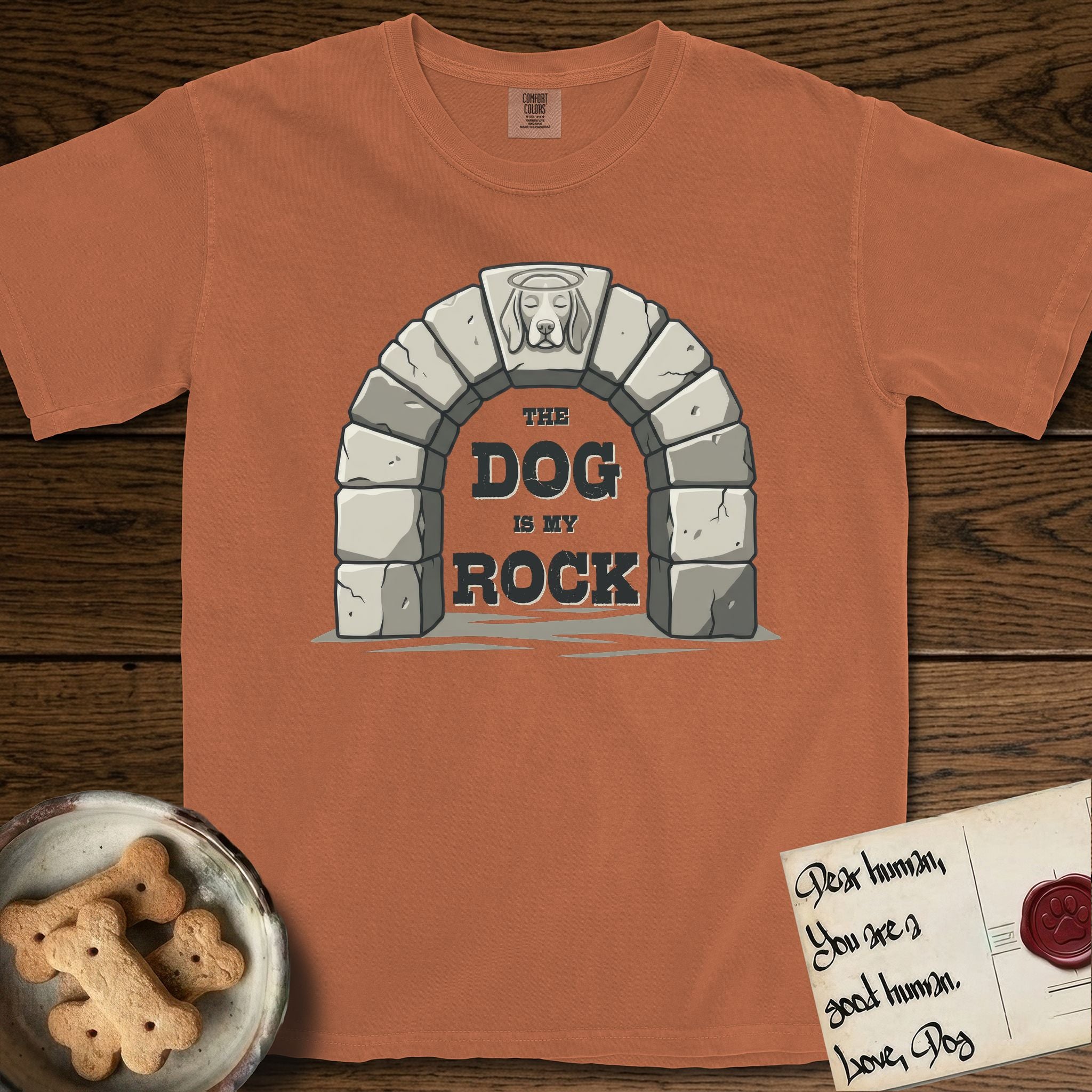 DIMR Beagle T-Shirt flat lay in Yam, featuring carved gray stone arch with a Beagle's face in shallow relief on the keystone and a halo above, with the words the Dog is my Rock.