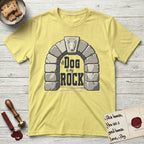 DIMR Bull Terrier T-Shirt flat lay in Cornsilk, featuring carved gray stone arch with a Bull Terrier's face in shallow relief on the keystone and a halo above, with the words the Dog is my Rock.