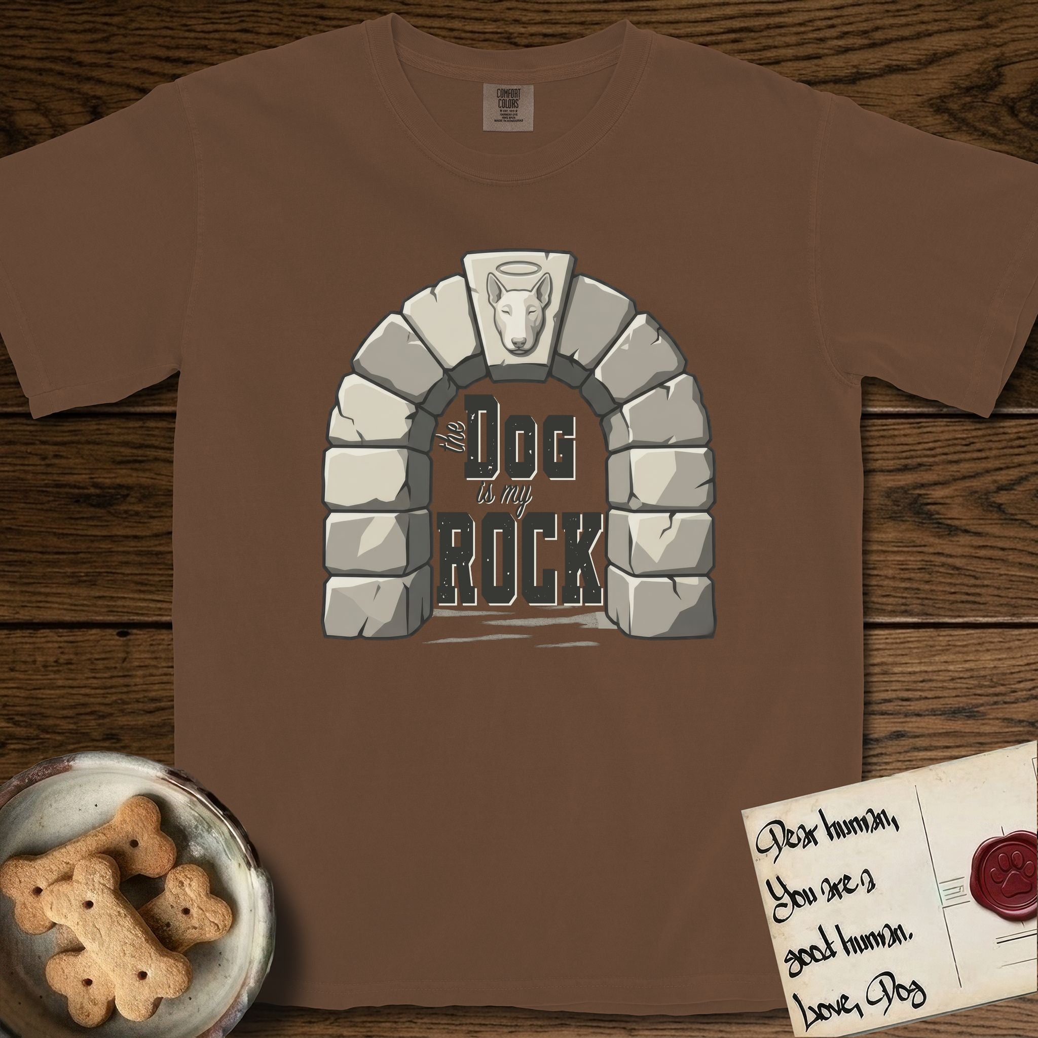 DIMR Bull Terrier T-Shirt flat lay in Espresso, featuring carved gray stone arch with a Bull Terrier's face in shallow relief on the keystone and a halo above, with the words the Dog is my Rock.