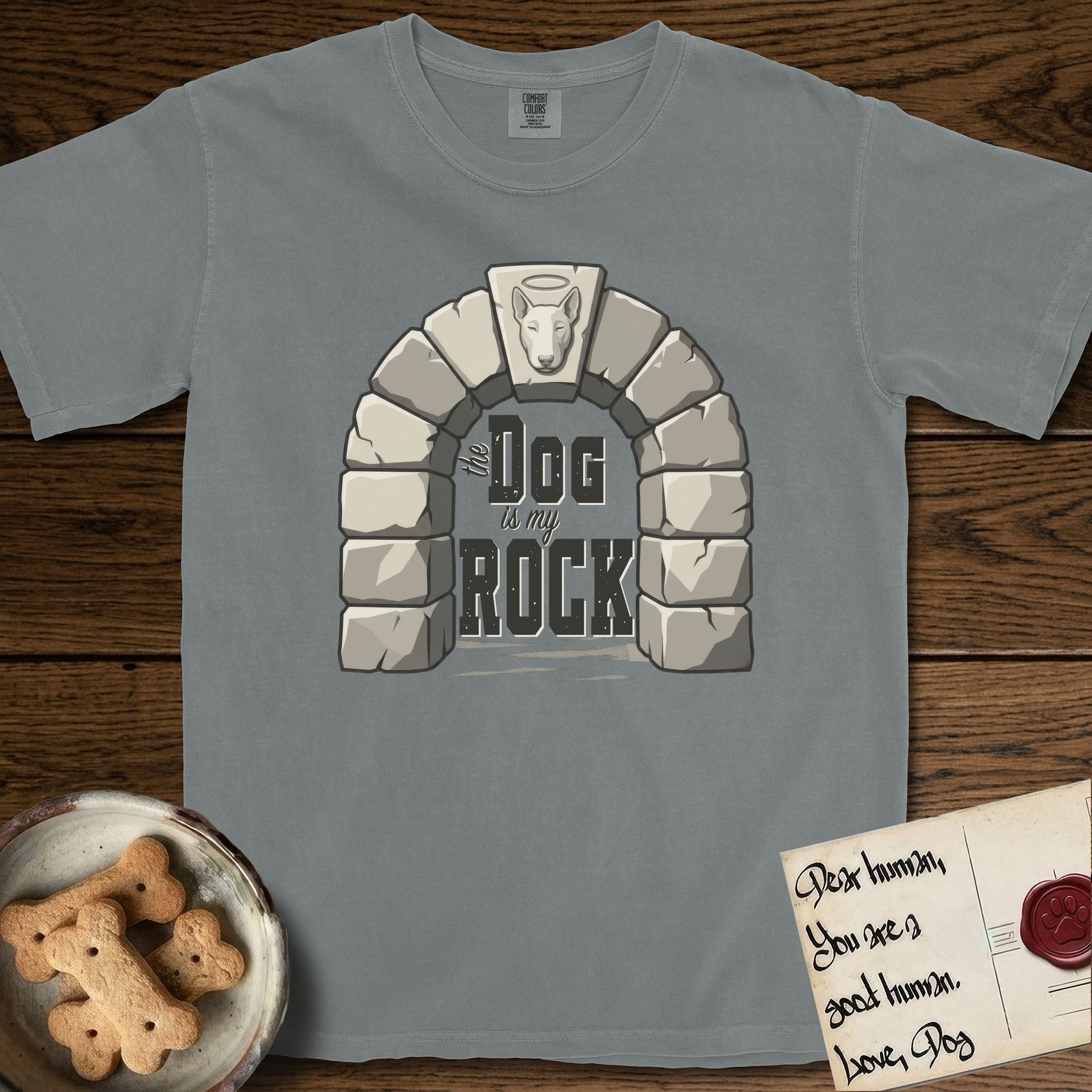 DIMR Bull Terrier T-Shirt flat lay in Granite, featuring carved gray stone arch with a Bull Terrier's face in shallow relief on the keystone and a halo above, with the words the Dog is my Rock.
