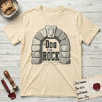 DIMR Bull Terrier T-Shirt flat lay in Natural, featuring carved gray stone arch with a Bull Terrier's face in shallow relief on the keystone and a halo above, with the words the Dog is my Rock.