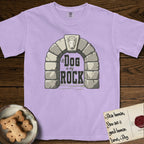 DIMR Bull Terrier T-Shirt flat lay in Orchid, featuring carved gray stone arch with a Bull Terrier's face in shallow relief on the keystone and a halo above, with the words the Dog is my Rock.