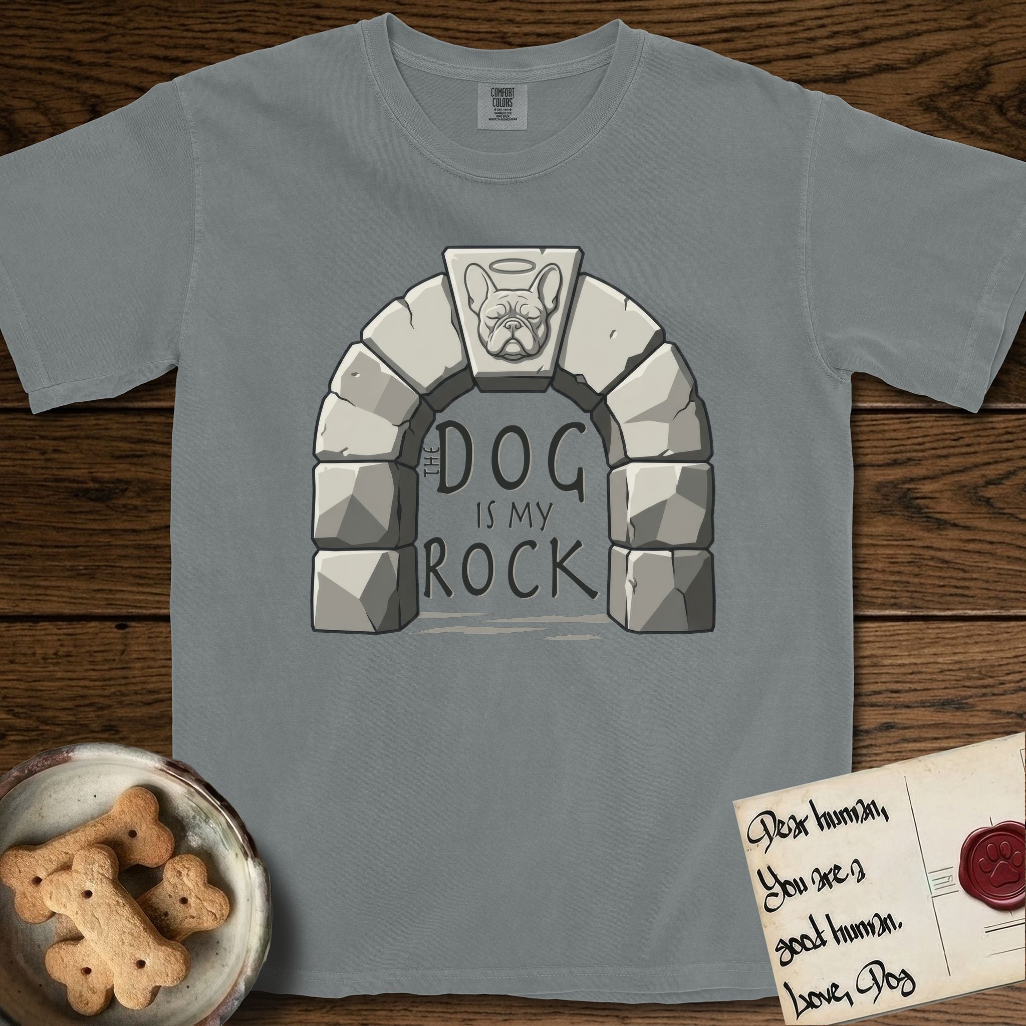 DIMR French Bulldog T-Shirt flat lay in Granite, featuring carved gray stone arch with a French Bulldog's face in shallow relief on the keystone and a halo above, with the words the Dog is my Rock.