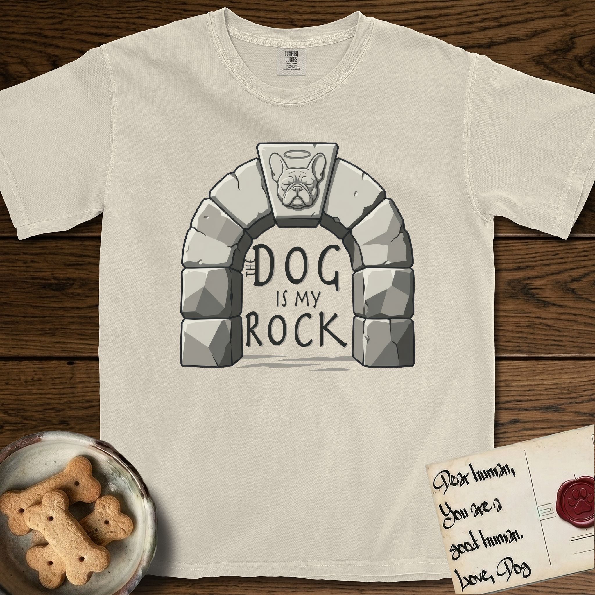 DIMR French Bulldog T-Shirt flat lay in Ivory, featuring carved gray stone arch with a French Bulldog's face in shallow relief on the keystone and a halo above, with the words the Dog is my Rock.