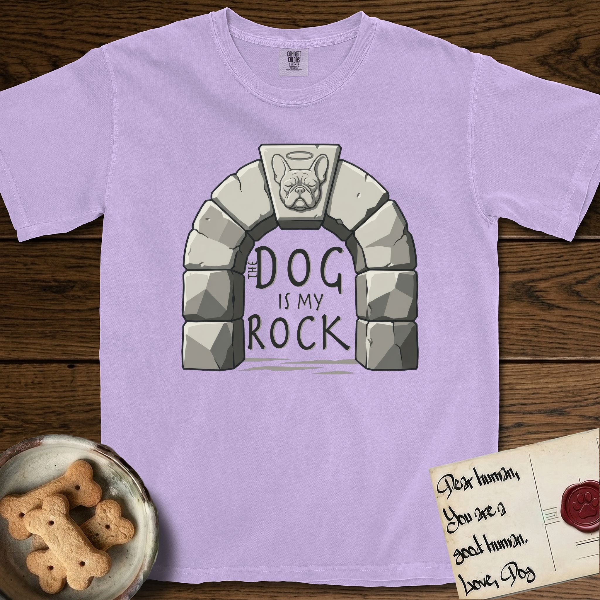 DIMR French Bulldog T-Shirt flat lay in Orchid, featuring carved gray stone arch with a French Bulldog's face in shallow relief on the keystone and a halo above, with the words the Dog is my Rock.